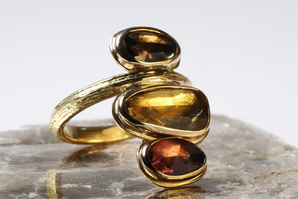 Gold toned ring with multiple gemstones